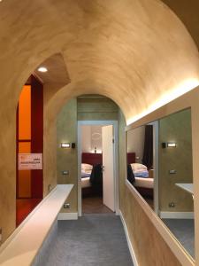 a room with a hallway with two beds at Artemide Guest House in Florence