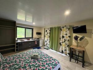 a bedroom with a bed and a desk and a window at Tuna House in Maroe