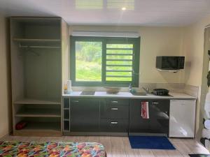 a kitchen with a sink and a window at Tuna House in Maroe +17 photos