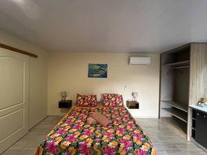 a bedroom with a large bed with a colorful blanket at Tuna House in Maroe