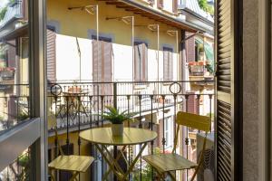a balcony with a small table and two chairs at Urban Retreat - Isola District in Milan