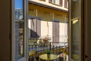 a view of a balcony from a window with a table at Urban Retreat - Isola District in Milan