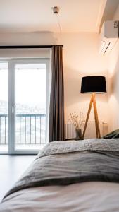 a bedroom with a bed with a lamp and a window at Si-View Einzelzimmer mit Balkon Zimmer 5 in Siegen