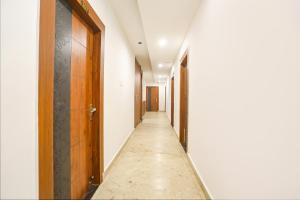 an empty corridor with a door at FabHotel Hari Kunj in Varanasi
