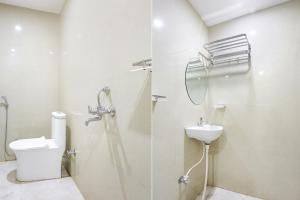 a bathroom with a shower and a toilet and a sink at FabHotel Hari Kunj in Varanasi