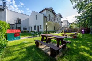 stół piknikowy w trawie obok budynku w obiekcie Apartamenty Plazowa w Darłówku