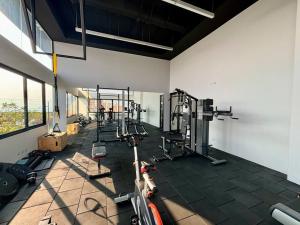 a gym with several tread machines in a room at Cozy apartment near Airport in Guatemala