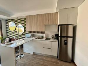 a kitchen with a stainless steel refrigerator at Cozy apartment near Airport in Guatemala