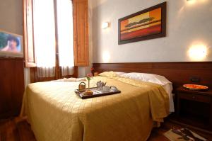 Postel nebo postele na pokoji v ubytování Hotel Palazzo Vecchio
