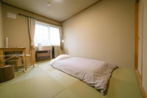 Postel nebo postele na pokoji v ubytování TESHIKAGA HOSTEL MISATO