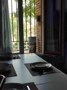 een tafel met borden op een aanrecht met een raam bij Miguel Ángel in Toledo
