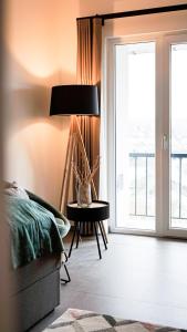 1 dormitorio con 1 cama y 1 mesa con lámpara en SI-View Einzelzimmer mit Balkon Zimmer 4 en Siegen