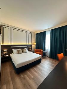 a hotel room with a bed and a table and chairs at Premiere Hotel in Klang