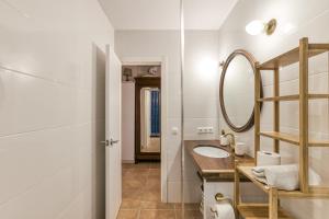 a bathroom with a sink and a mirror at Calella Pallafrugell in Palafrugell +21 photos