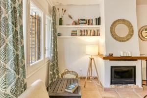 a living room with a fireplace and a chair at Calella Pallafrugell in Palafrugell