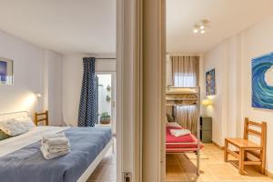 a bedroom with a bed and a red chair at Calella Pallafrugell in Palafrugell