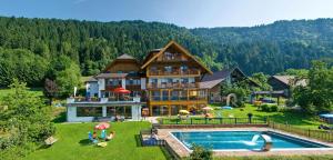 a large house with a pool in front of it at nawu apartments & Restaurant in Hermagor