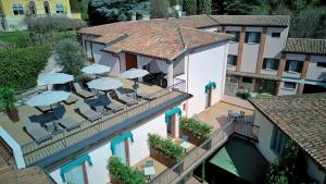 an aerial view of a building with chairs and umbrellas at Hotel Meridiana in Sirmione