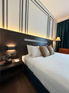 a bedroom with a large white bed and a window at Premiere Hotel in Klang