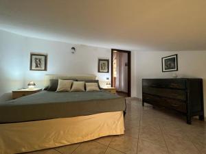 a bedroom with a large bed and a dresser at Casa vacanze Monte in Castellino Tanaro