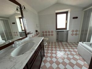 y baño con lavabo, bañera y aseo. en Casa vacanze Monte, en Castellino Tanaro