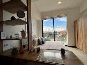 a living room with a large window with a view at UaSenua -Beautiful New Apartment in Guatemala