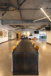 a long table in a large room with chairs at UaSenua -Beautiful New Apartment in Guatemala