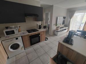 a kitchen with a washing machine and a microwave at Quiet 3 bed all to yourself in Avalon