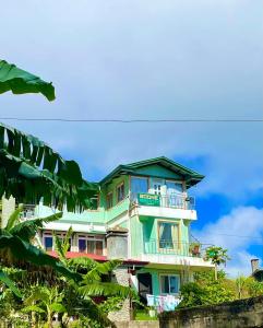 a tall building with a balcony on the side of it at Couple's Unit at BOONE'S in Sagada