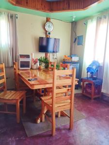 a dining room with a wooden table and chairs at Couple's Unit at BOONE'S in Sagada
