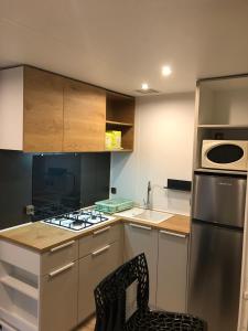 a kitchen with a stove and a refrigerator at Best Holiday Port Grimaud in Grimaud