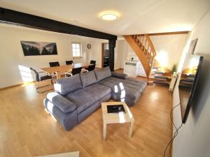 a living room with a couch and a table at Zauberhaft übernachten - nur 7 min vom Europa-Park in Ettenheim