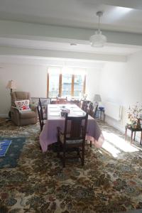 a living room with a table and chairs and a couch at Holywell Lodge in Ballyheelan