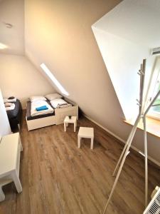a small attic bedroom with a bed and a table at Zauberhaft übernachten - nur 7 min vom Europa-Park in Ettenheim