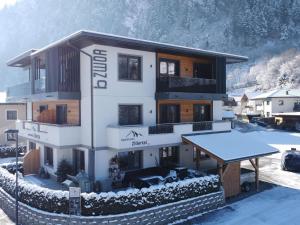 a building in the snow with a table in front of it at Spacious Apartment near Ski Area in Mayrhofen in Mayrhofen