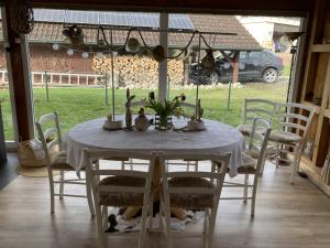 a dining room table with a white table cloth and chairs at Escale sur la Côte in Porrentruy