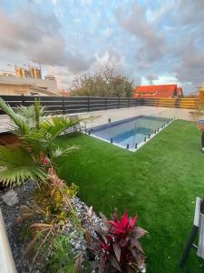 a backyard with a swimming pool and green grass at בית בים in Netanya