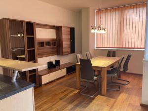 a dining room with a wooden table and chairs at Apartment TAMINO TOP 2 in Schladming +26 photos