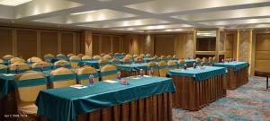 a conference room with blue tables and chairs at Coronet The Boutique Hotel in Pune