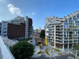 a city with two tall buildings and a street at Nice Apartment in Zone 4 in Guatemala