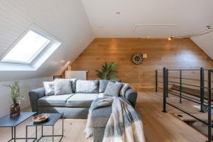 a living room with a couch and a window at Beautiful and spacious vacation home 'Villa Willy' in Blankenberge