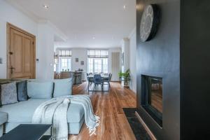a living room with a blue couch and a fireplace at Beautiful and spacious vacation home 'Villa Willy' in Blankenberge