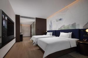 Cama o camas de una habitación en Hampton by Hilton Shenzhen Nanshan Science and Technology Park