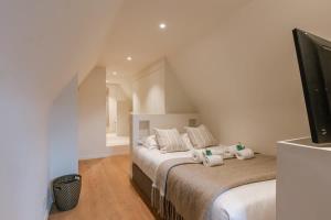 a bedroom with a bed with towels on it at Beautifully decorated villa near the city of Knokke in Knokke-Heist