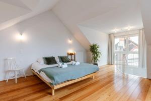 a bedroom with a bed and a large window at Central 'The Crown' apartment in Ghent in Ghent