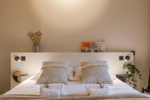 a bedroom with a white bed with white sheets and pillows at WAY SWEET DREAMS - Room 2 in Ghent