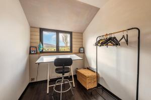 a small kitchen with a table and a stool in a room at Charme et Hâvre de Paix - Grand jardin in Trégarvan +8 photos