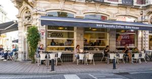 a group of people sitting at tables outside a restaurant at WAY SWEET DREAMS - Room 1 in Ghent