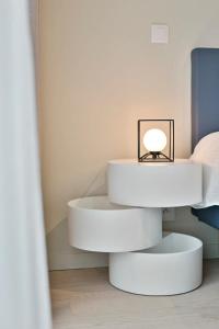 a white table with a lamp on it in a room at Fabulous house near the sea in the Modern O'Sea building in Ostend