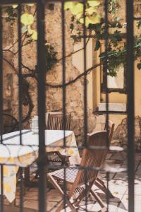 a table and chairs sitting in front of a building at Maison Pelissier - Chambres d’hôtes avec piscine in Cuxac-dʼAude
